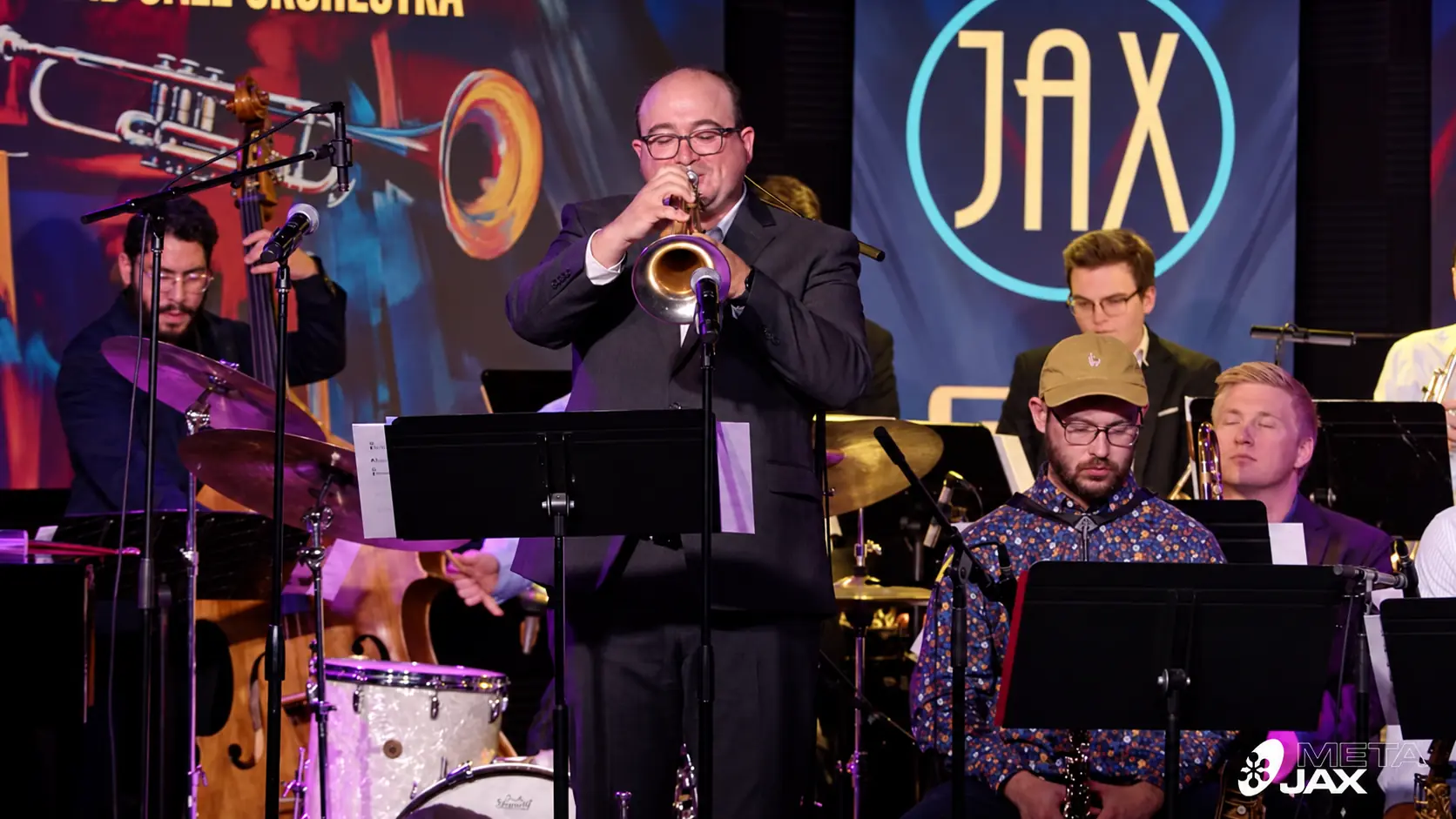 Ryan DeWeese playing trumpet with his orchestra at Campus JAX, April 24, 2025